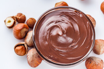 chocolate butter and hazelnuts on a white acrylic background