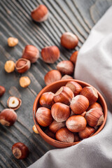 fresh natural hazelnuts on a dark wooden rustic background
