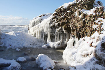 rocks on the beach covered in ice