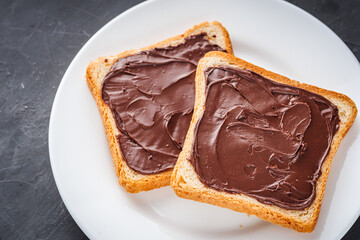 toasts with chocolate butter on a dark stone background