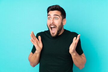 Caucasian handsome man isolated on blue background with surprise facial expression