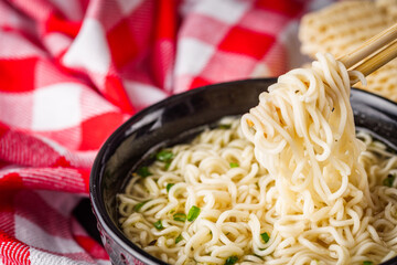 instant egg noodles on a dark stone background
