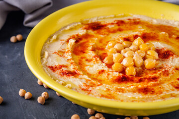 traditional turkish hummus on a dark stone background