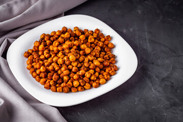 fried chickpeas on a dark stone background