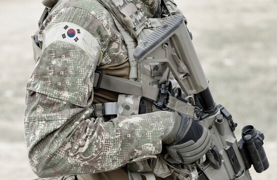 Soldier With Assault Rifle And Flag Of South Korea On Military Uniform. Collage.