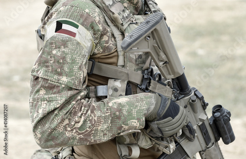 Soldier with assault rifle and flag of Kuwait on military uniform. Collage.