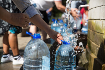 people Collecting natural spring water with 5 litre plastic water bottle at Newlands natural spring...