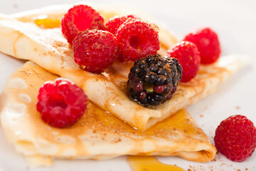 pancakes with raspberries, blackberries and honey