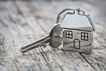 House key on a house shaped keychain background