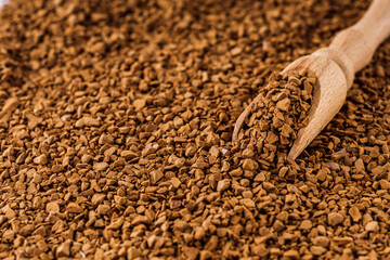 instant coffee granules on a white acrylic background