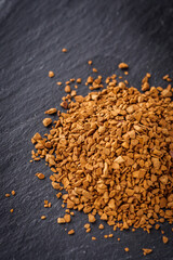 instant coffee granules on a dark stone background