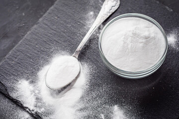 baking soda powder on a dark stone background