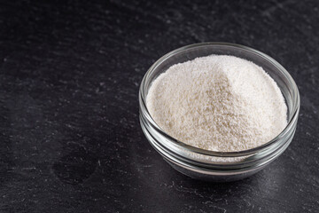 granulated milk powder on a dark stone background