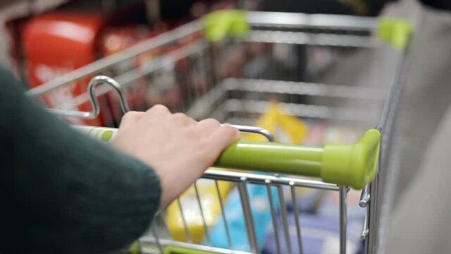 Woman pushing a shopping cart in the supermarket