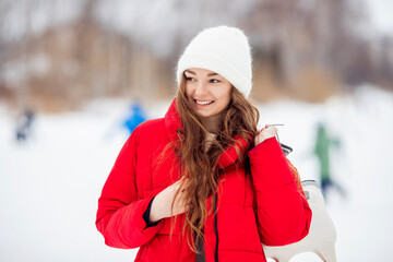 Portrait smile woman skating on ice city rink sunset in winter