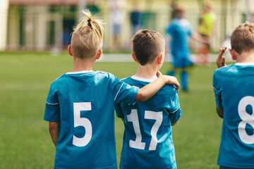 Fototapeta premium Soccer Boys Teammates. Friendship in a School Sports Team. Happy Kids Standing Together and Watching Football Match