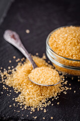 cane brown sugar on a dark stone background