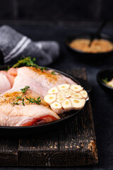 Raw uncooked chicken thighs with garlic