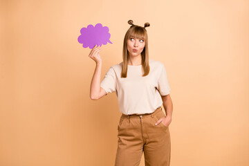 Photo portrait of girl keeping cloud dreaming having idea thoughtful looking copyspace pouted lips isolated on pastel beige color background