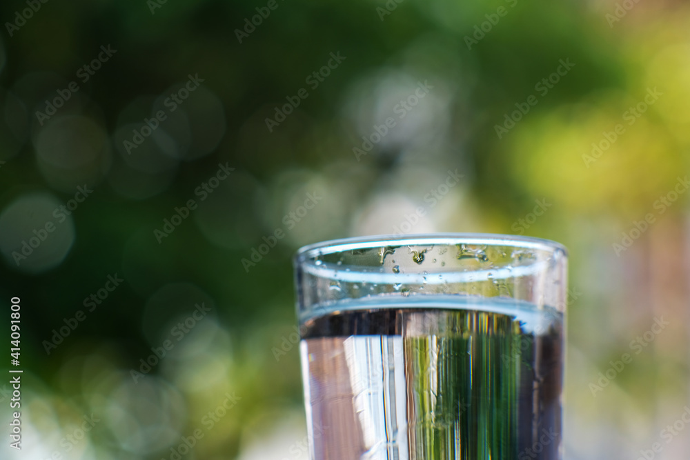 Poster glass of water on green background