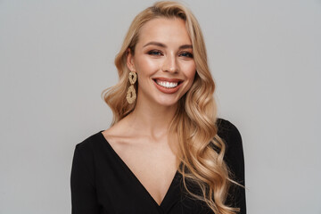 Happy girl in luxury earrings smiling and looking at camera