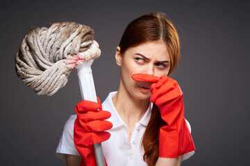 cleaning lady covers her nose with her fingers unpleasant smell mop in hand cleaning discontent