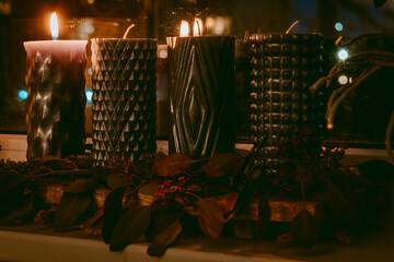 Modern Advent wreath or crown on a wooden plank with dried plants and four blue candles
