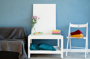 Mock up white poster frame on coffee table in blue room