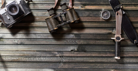 a set of equipment for a hike on a dark wooden background. close-up, copy space.
