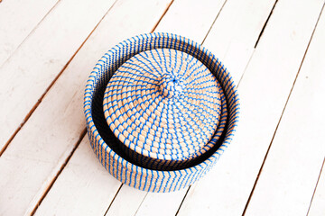Straw and wicker furniture and baskets in the interior. Scandinavian style of decoration of a room or apartment