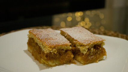 Hungarian apple cake with a luminous ornament in the background