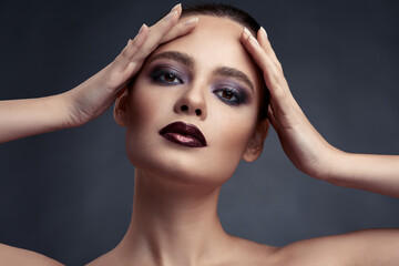 Beauty portrait of woman with smokey eyes make-up