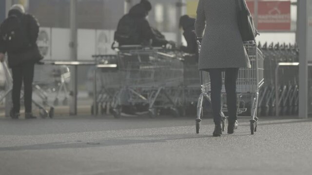 People push shopping cart in front of the store.