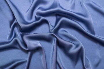 Blue silk or satin luxury fabric texture. Top view.