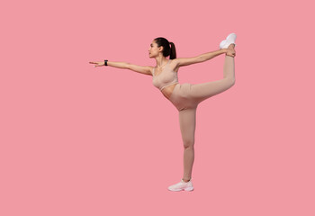 Young Woman Doing Balance Exercise With Leg Raise