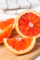 Slices of red orange on wooden board, closeup