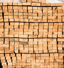 Square wooden planks stacked on a construction site.