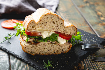 Large sandwich with turkey, vegetables and whole grain bread