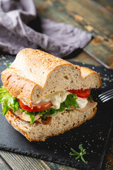 Large sandwich with turkey, vegetables and whole grain bread