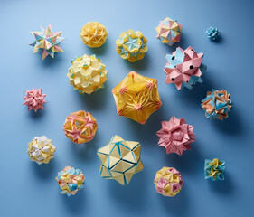 Set of multicolor handmade modular origami balls or Kusudama Isolated on blue background. Visual...