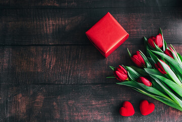 Bouquet of red tulips on a wooden background. Spring flowers. Mother's Day background.