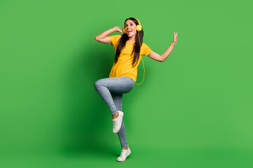 Full size photo of happy funny young woman dancer dj party mood isolated on shine green color background