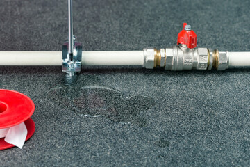 Water leak on a water pipe. Repair of broken pipe on title surface with copy space.