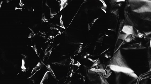 Light Passes Over Crumpled Aluminium Foil. - studio shot