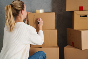 Smiling attractive young woman moving out