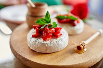 Grilled camembert cheese with strawberry, honey and basil leaves, delicatessen