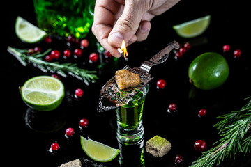 absinthe poured into a glass. alcoholic drink with brown sugar and lime. Absinthe or mint liquor...