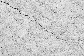 A crack crossing a gray concrete wall diagonally.