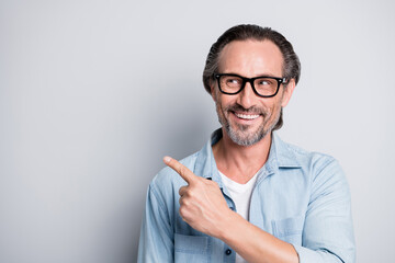 Photo of handsome man happy smile look point finger empty space advert promo select recommend...