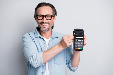 Photo of handsome man happy smile pay paypass terminal shopper buy isolated over grey color background